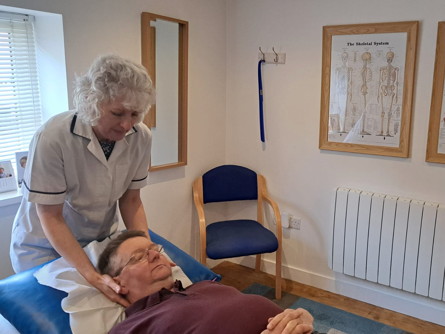 Person lying on treatment bed in Okehampton Osteopathic Clinic's treatment room